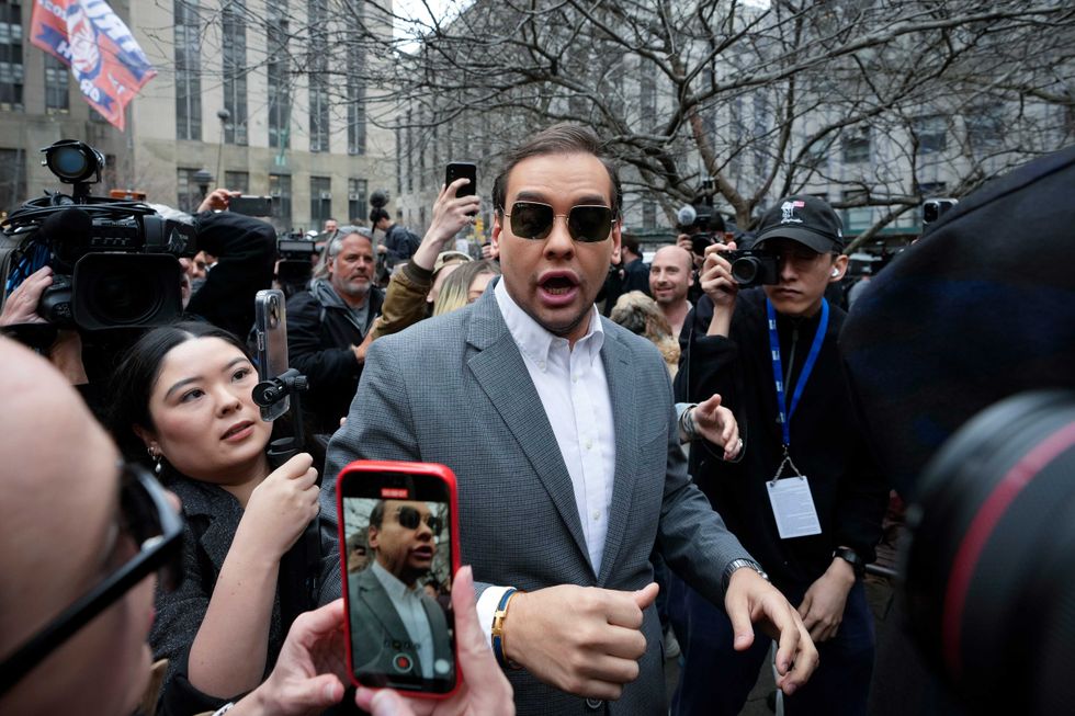 U.S. Rep. George Santos (R-NY) walks through the crowd gathered outside the courthouse on April 4, 2023