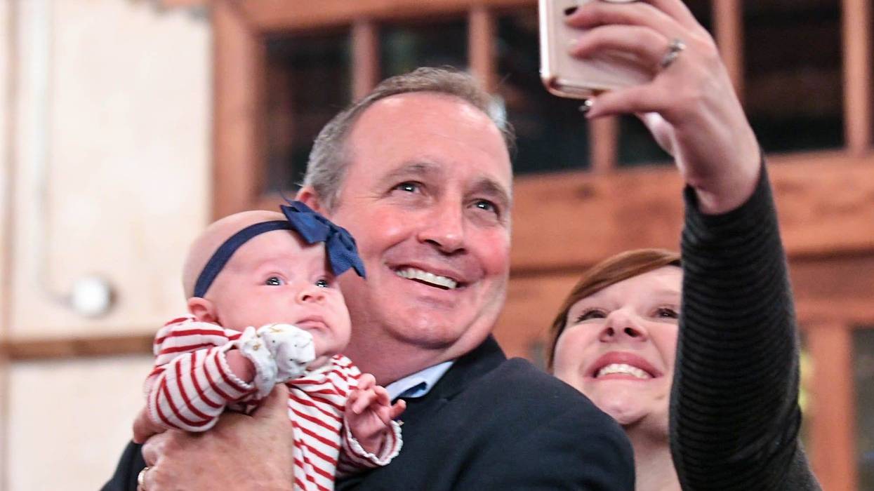 U.S. Rep. Jeff Duncan, middle, holds Ellyson Duncan, the baby of his niece in law Somer Duncan, right, getting a selfie photo, minutes before he was projected to win his fifth term in District 3, during election night party in Anderson on Tuesday, Novembe