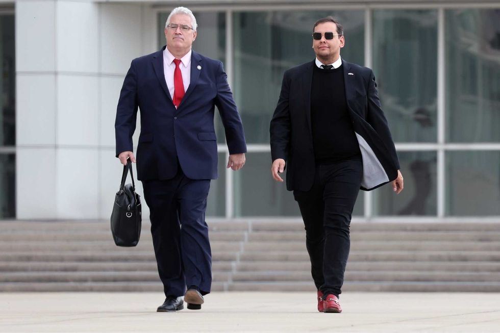 U.S. Representative George Santos (R-NY) walks out of a federal courthouse in Long Island with his lawyer Joe Murray on Oct. 27, 2023 in Central Islip, New York