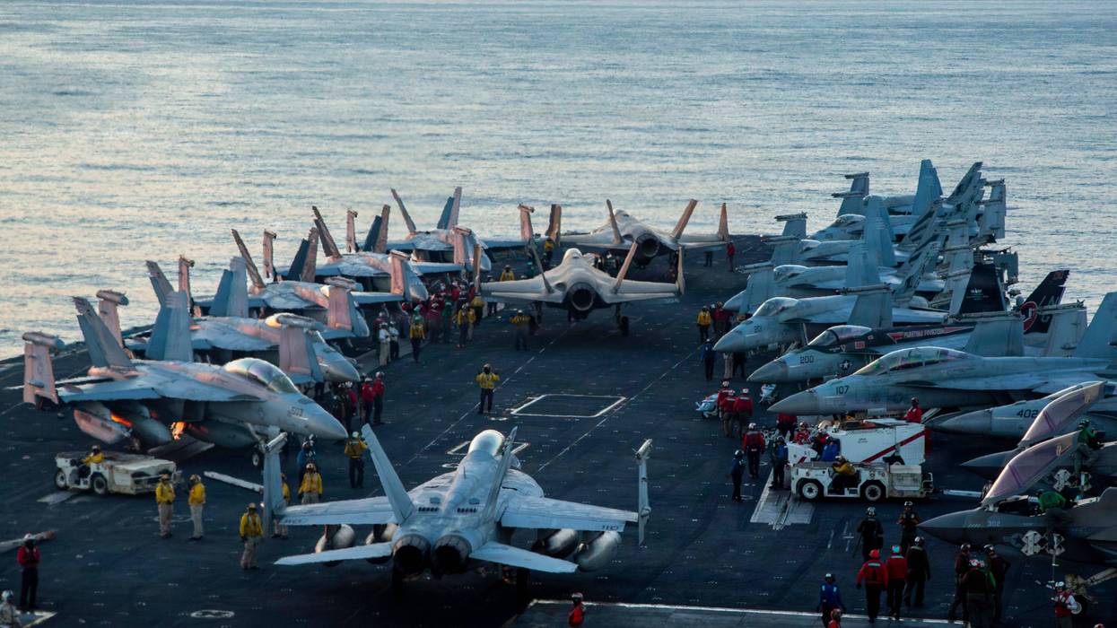 U.S. Sailors taxi aircraft to a staging point on the flight deck of Nimitz-class aircraft carrier USS Abraham Lincoln (CVN 72) in support of Operation Epic Fury, Feb. 28, 2026.