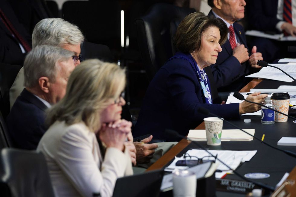 U.S. Sen. Amy Klobuchar (D-MN) (R) looks on as U.S. Attorney General Pam Bondi testifies before the Senate Judiciary Committee in the Hart Senate Office Building on Capitol Hill on October 07, 2025 in Washington, DC. Bondi is expected to face criticism from Democrats on the Justice Department’s targeting of President Trump’s political opponents, including the recent indictment of former FBI Director James Comey.