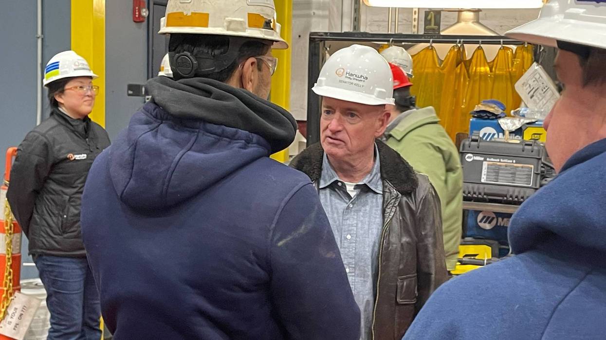 U.S. Sen. Mark Kelly of Arizona (center) visits a training facility at the Philly Shipyard on Tuesday, Feb. 18.
