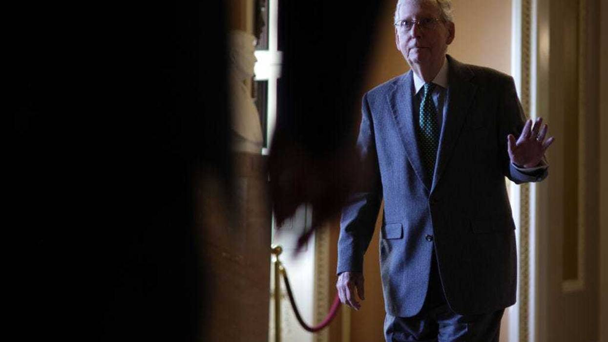 U.S. Senate Minority Leader Sen. Mitch McConnell (R-KY) waves to a person passing by as he walks in a hallway at the U.S. Capitol on February 29, 2024 in Washington, DC. The Senate continues to work on a interim spending bill to fund the government. (Photo by Alex Wong/Getty Images)