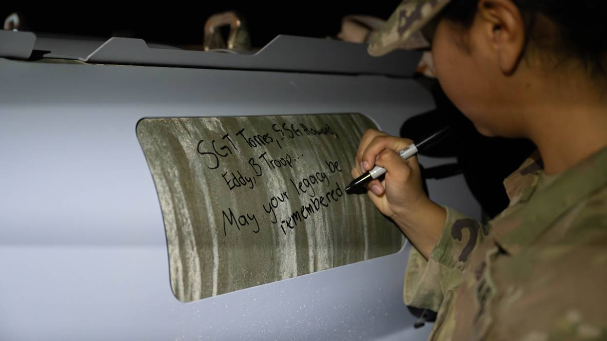 U.S. soldiers attached to the Iowa National Guard sign GBU-31 munitions systems in the U.S. Central Command area of responsibility Dec. 18, 2025.