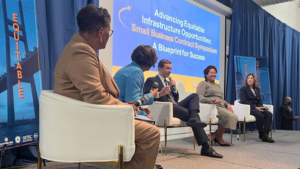 U.S. Transportation Secretary Pete Buttigieg at an event in West Philadelphia encouraging Black and other minority contractors to get involved in the contracts becoming available through projects funded by the Bipartisan Infrastructure Act. At left: Della Clark, president of the Enterprise Center in West Philadelphia.