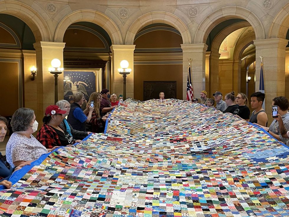\u200bCrafted from contributed fabric squares, project leaders explained that the blanket was created to spotlight ongoing local detentions