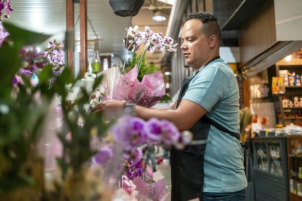 \u200bFlorist works with an arrangement in his workshop