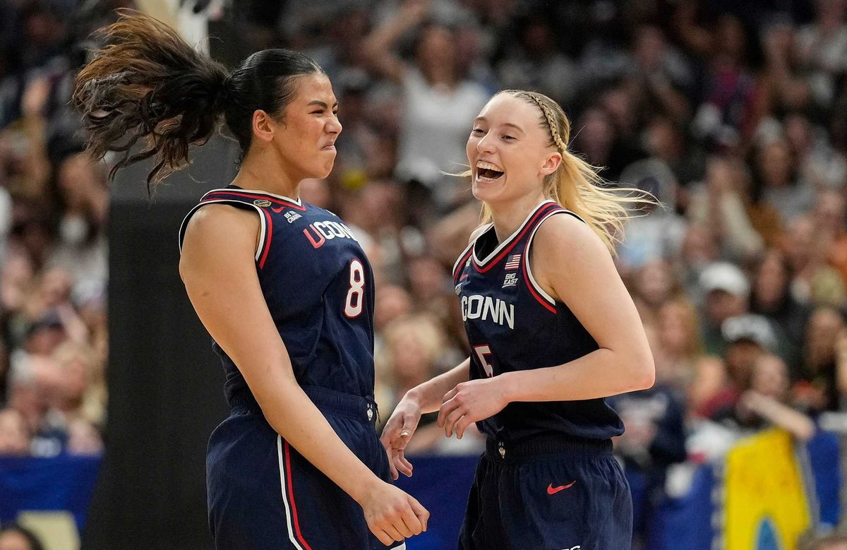 UConn center Jana El Alfy (8) and UConn guard Paige Bueckers (5) react during the first half of a national semifinal Final Four game against UCLA during the women's NCAA college basketball tournament, Friday, April 4, 2025, in Tampa, Fla.