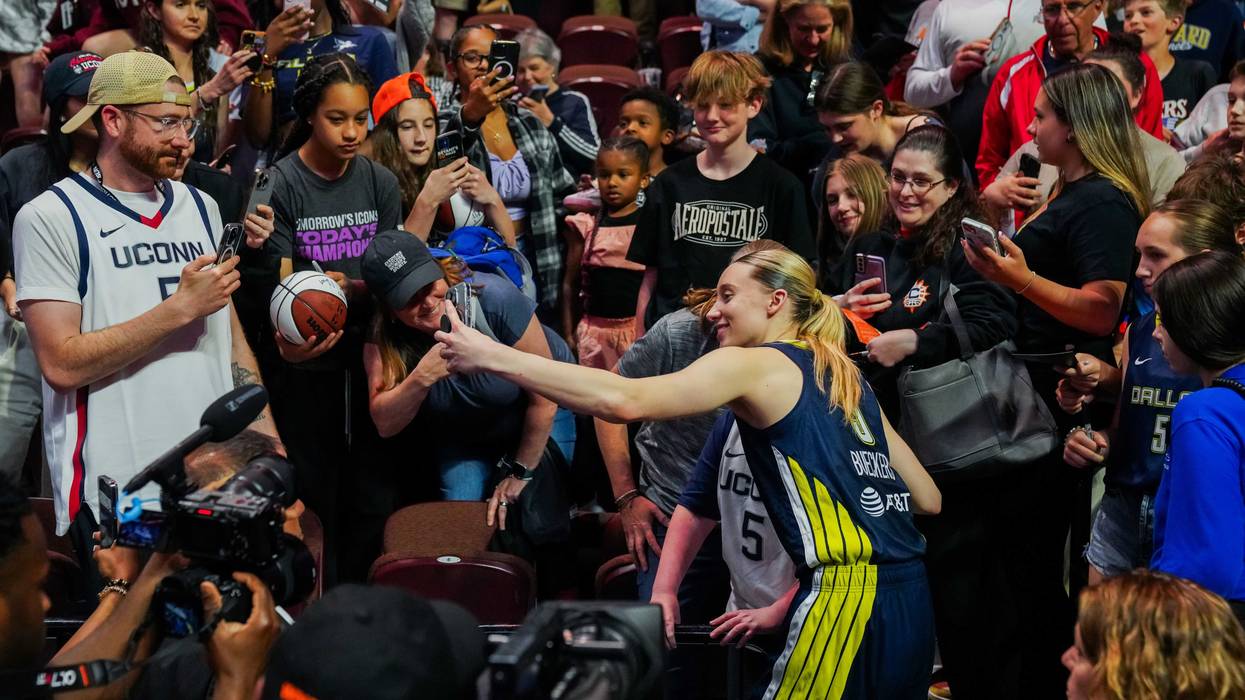 UConn great Paige Bueckers poses with fans at Mohegan Sun after she picked up her first win as a professional. She scored 21 points as her Dallas Wings beat the Connecticut Sun, 109-87.