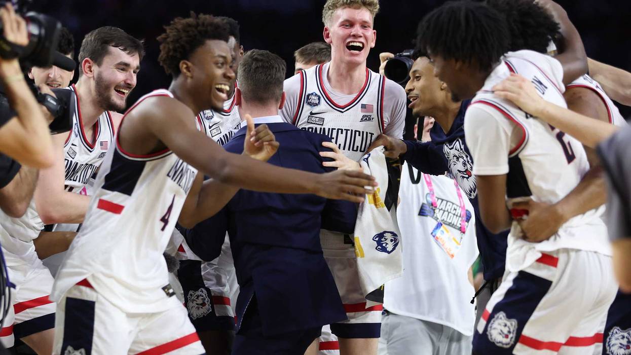 UConn's Nahiem Alleyne celebrates with teammates after defeating San Diego State for the NCAA championship on April 03, 2023 in Houston, Texas.