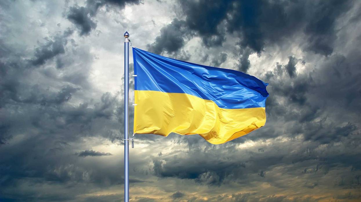 Ukraine flag. Ukrainian flag on black storm cloud sky. stormy weather