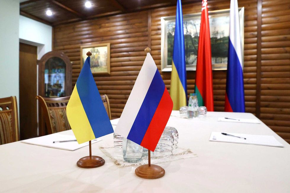 Ukrainian and Russian flags are seen at the talks Monday