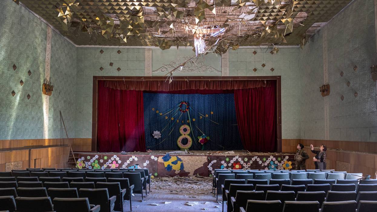 Ukrainian Army Lt. Karyna Skubak, 24, and village leader Dina, 62 inspect a bomb-damaged auditorium in a town which was, until recently, partially occupied by Russian forces in Kherson Oblast on May 08, 2022 in Zagradivka, Ukraine.