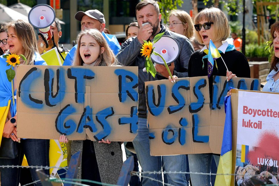 Ukrainian demonstrators demand an embargo on Russian oil during a protest in front of EU institutions