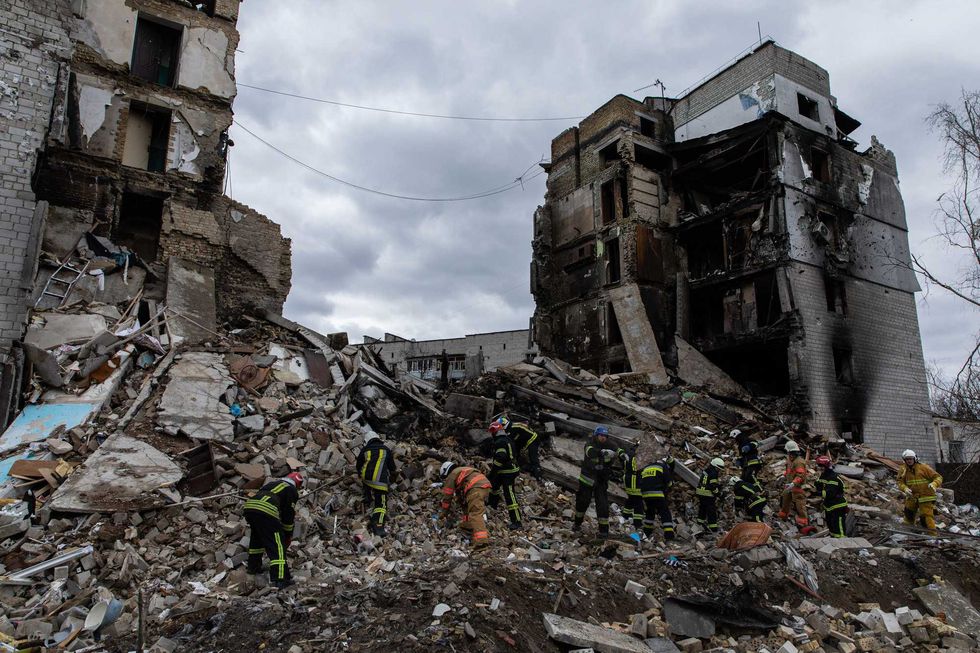 Ukrainian firefighters searching for survivors under the ruins of a destroyed residential building in Borodyanka, Kyiv Oblast, on April 6, 2022