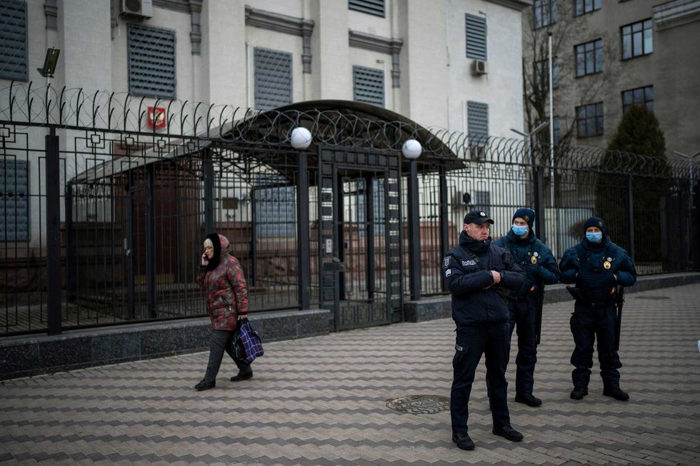 Ukrainian police officers stand guard in front of the Russian Embassy in Kyiv, Ukraine, Wednesday, Feb. 23, 2022