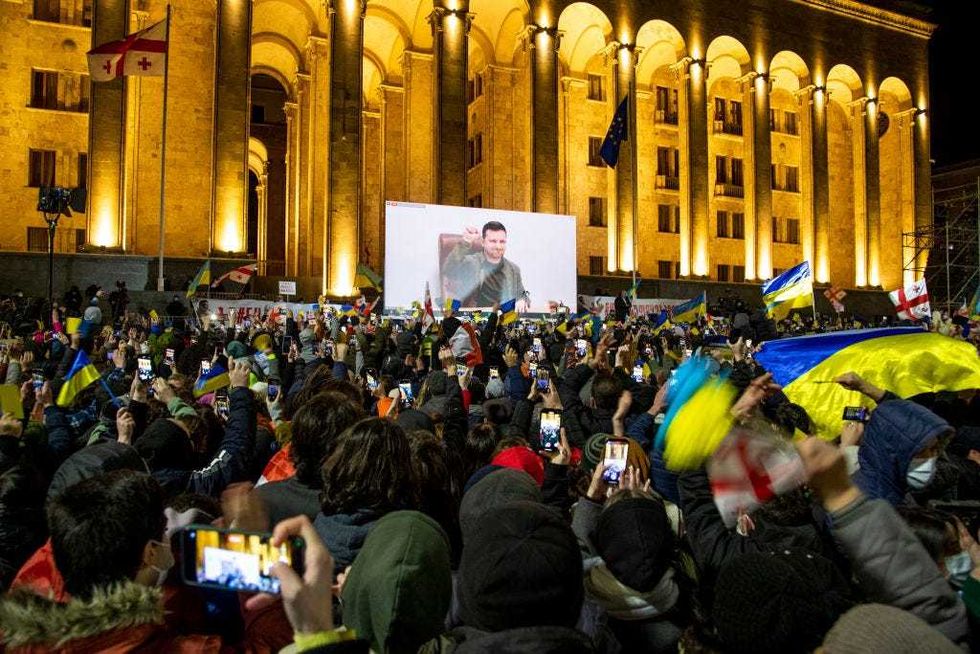 Ukrainian President Volodymyr Zelensky speech is streamed live on a big screen in front of Parliament during a rally in support of Ukraine on March 4, 2022 in Tbilisi, Georgia.