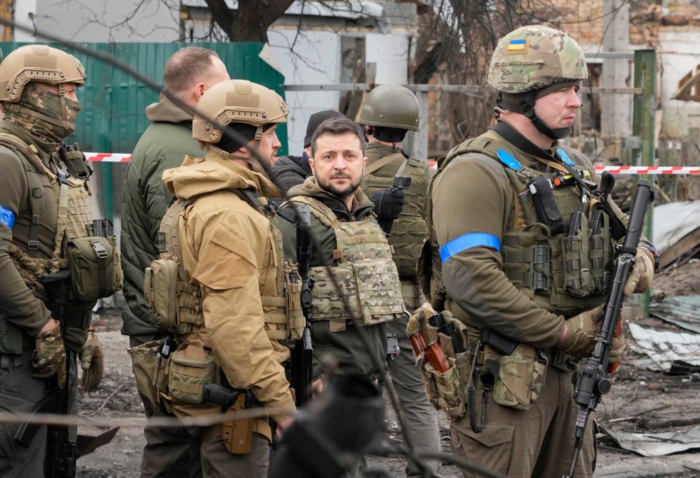 Ukrainian President Volodymyr Zelenskyy examines the site of a recent battle, in Bucha close to Kyiv, Ukraine, Monday, Apr. 4, 2022