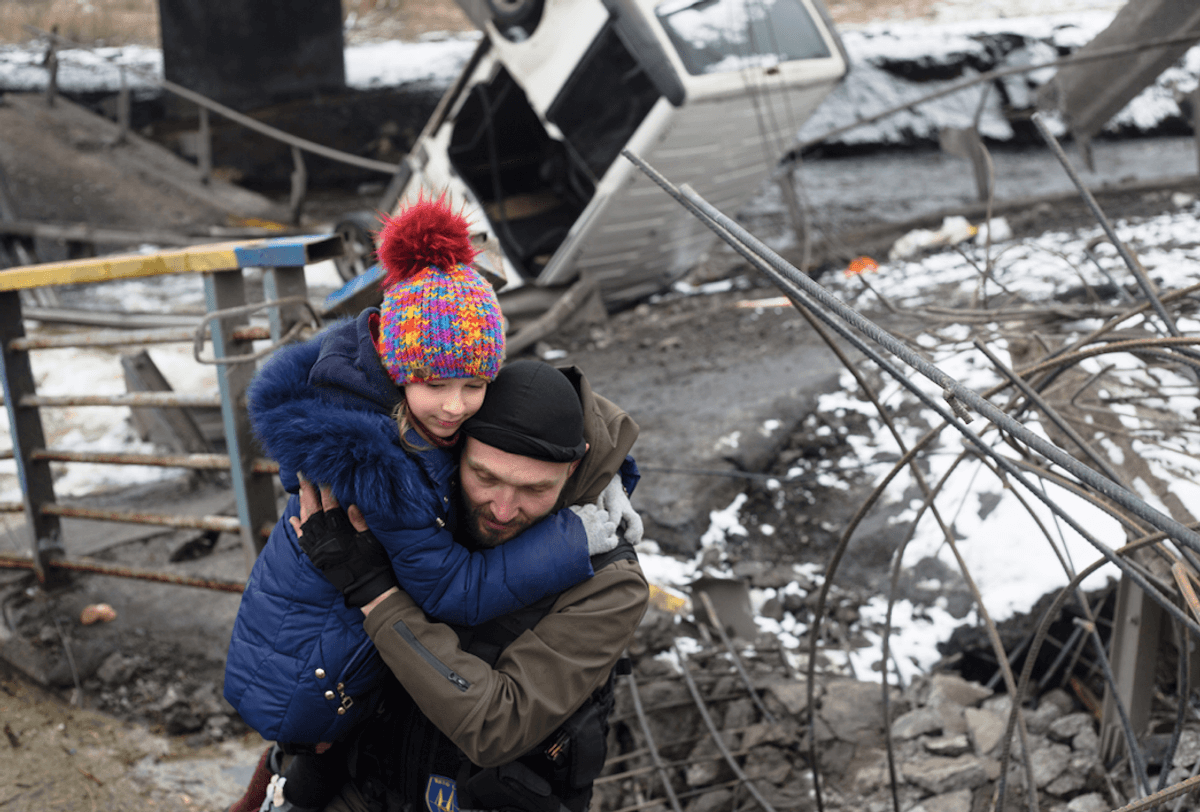 Ukrainian soldier helps child