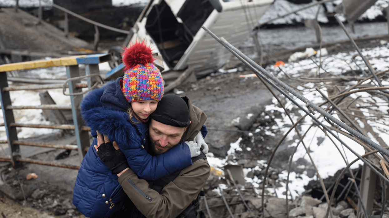 Ukrainian soldier helps child