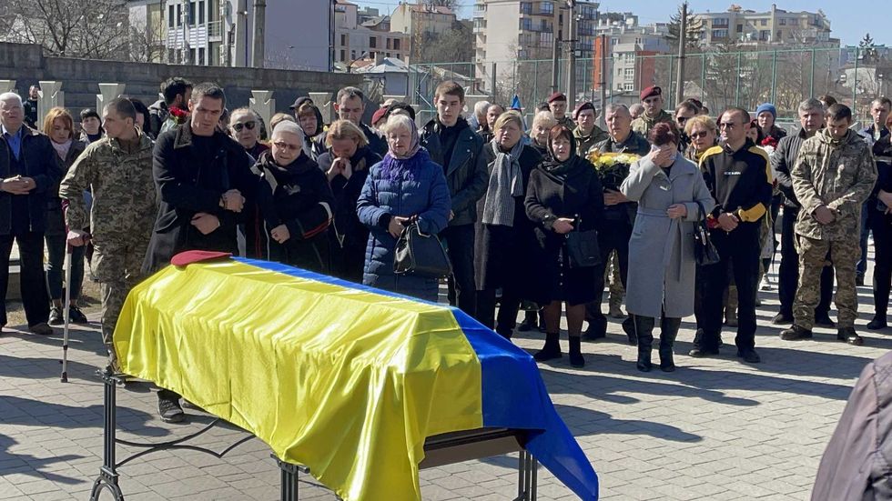 Ukrainian soldiers and civilians attend a funeral ceremony of Ukrainian soldier Igor Fedorchuk, who lost his life during Russian attacks on Nova Kakhovka, located near Russia