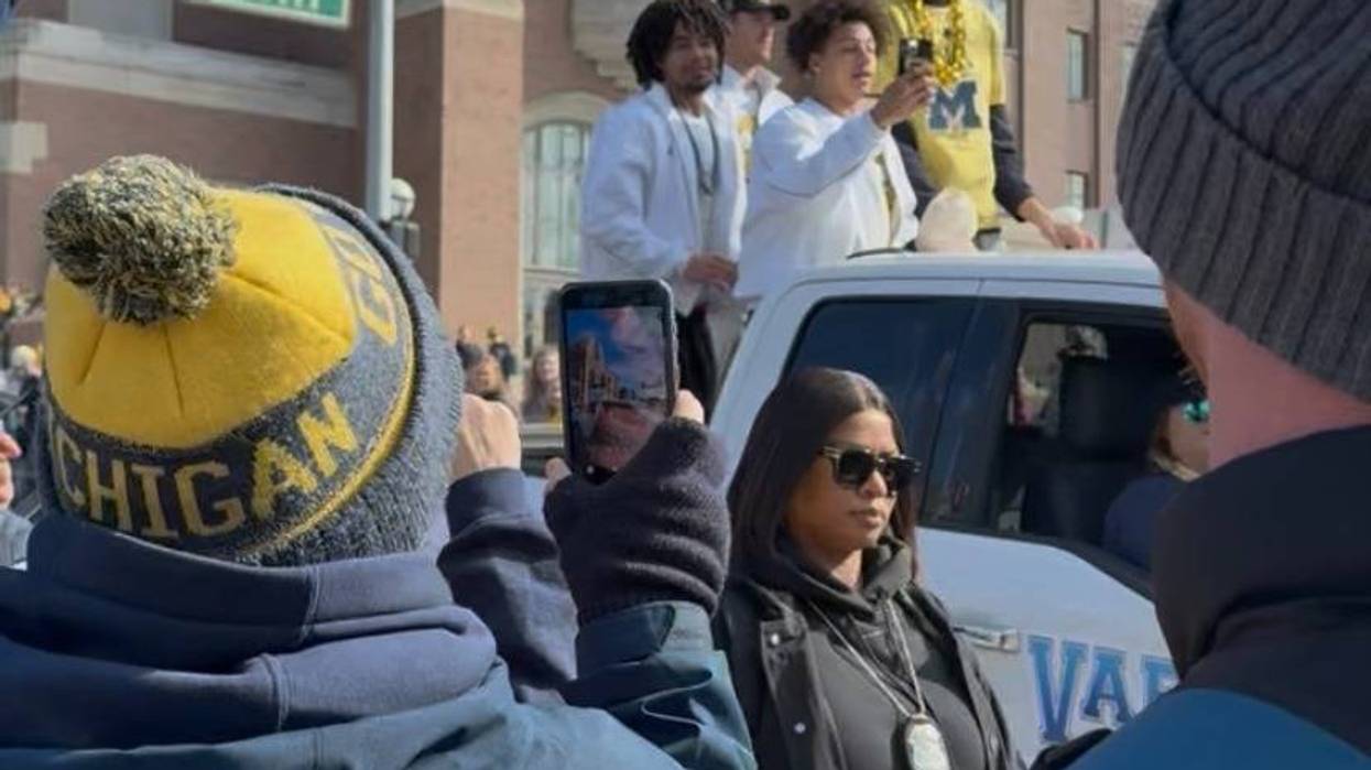UM players ride in a championship parade on Saturday