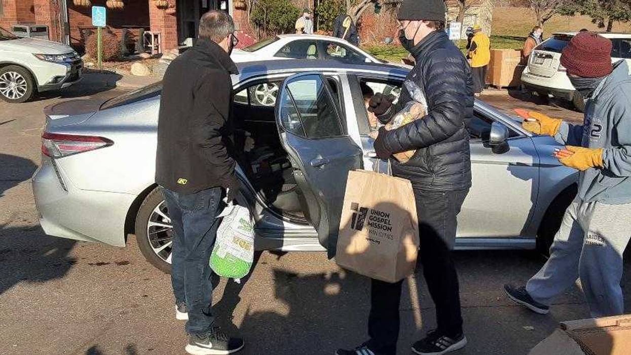 Union Gospel Mission volunteers load up car with Thanksgiving food in annual giveaway