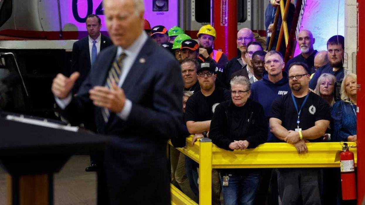 Union members and Amtrak workers listen as U.S. President Joe Biden announces more than $16 billion in new funding for rail projects on the Northeast Corridor while surrounded by trains inside the Amtrak Bear Heavy Maintenance Facility on November 06, 2023 in Bear, Delaware. Last week Biden threatened to veto legislation proposed by House Republicans for FY2024 that would cut Amtrak funding by 64% below the 2023 enacted level. (Photo by Chip Somodevilla/Getty Images)