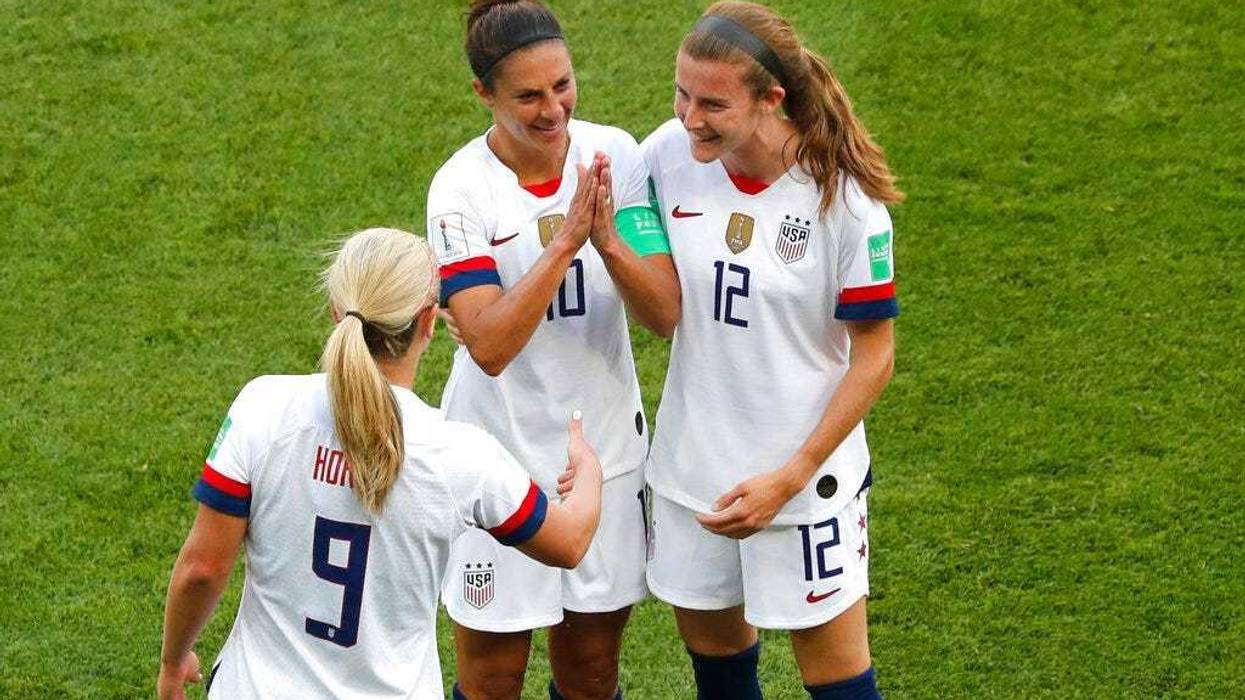 United States' Carli Lloyd , center, celebrates with Lindsey Horan and Tierna Davidson, right, after scoring the opening goal during the Women's World Cup Group F soccer match between the United States and Chile at the Parc des Princes in Paris, Sunday, J