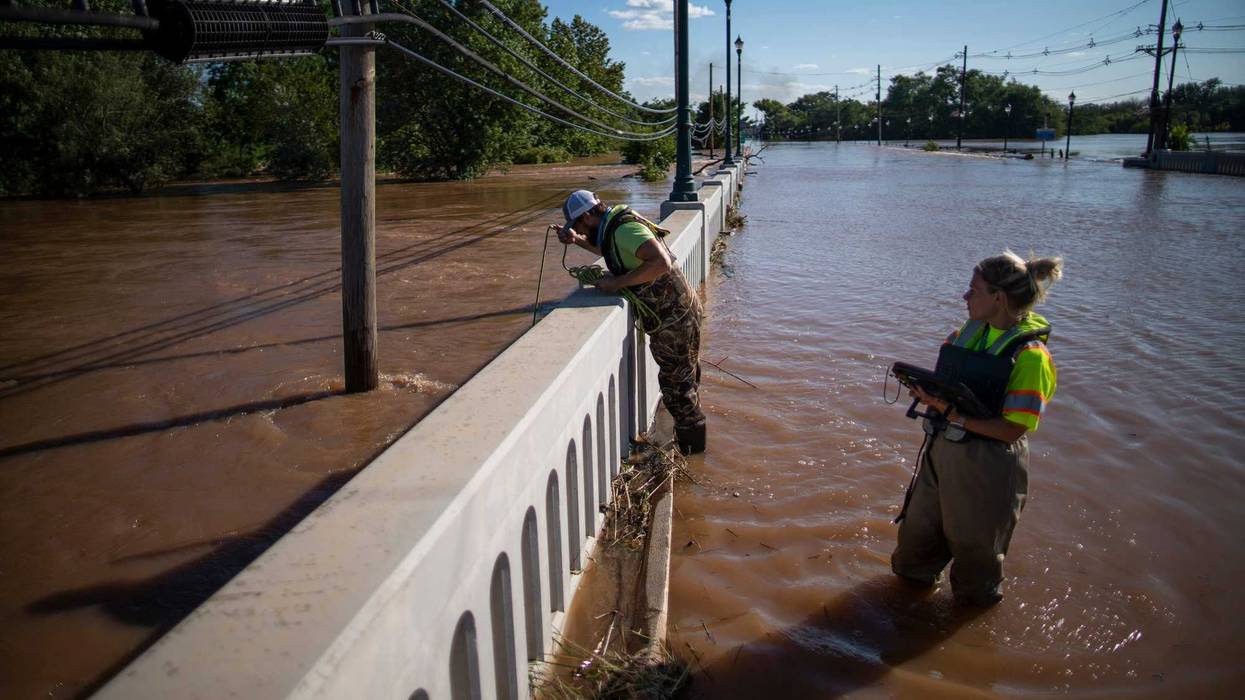 United States Geological Survey workers measure the floodwaters along the Raritan River in Somerville, N.J