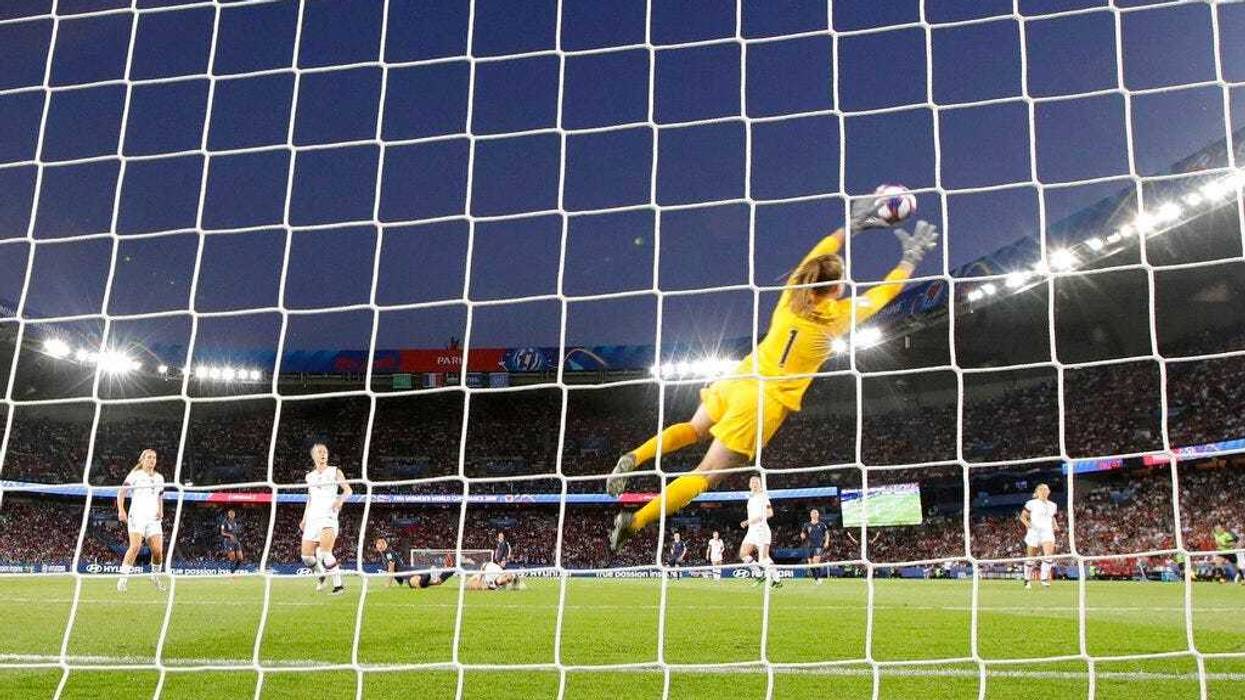 United States goalkeeper Alyssa Naeher is airborne as she makes a save during the Women's World Cup quarterfinal soccer match between France and the United States at Parc des Princes in Paris, France, Friday, June 28, 2019.