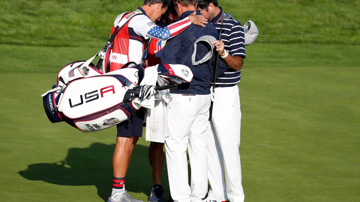 United States golfer Webb Simpson and United States golfer Bubba Watson huddle