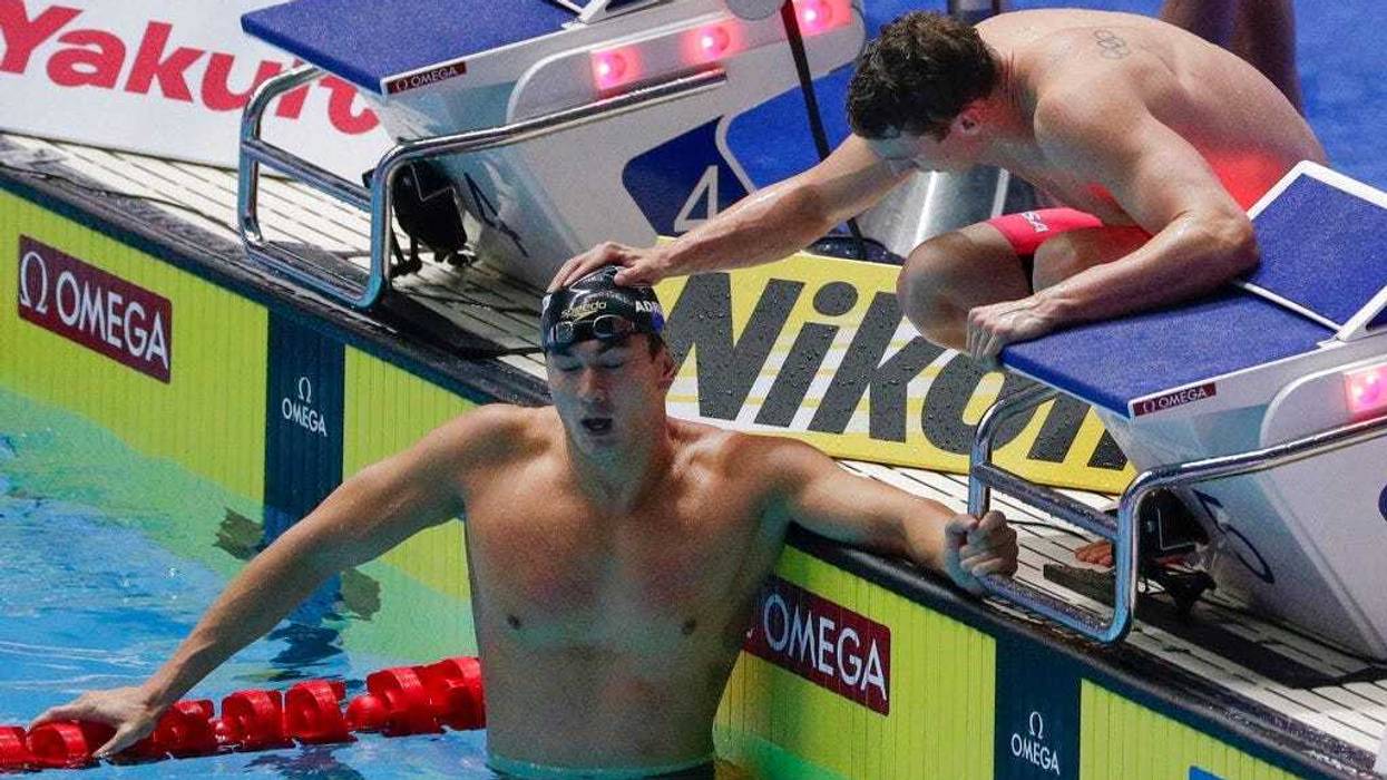 United States Nathan Adrian is consoled by a teammate after their second place finish in the men's 4x100m medley relay final at the World Swimming Championships in Gwangju, South Korea, Sunday, July 28, 2019