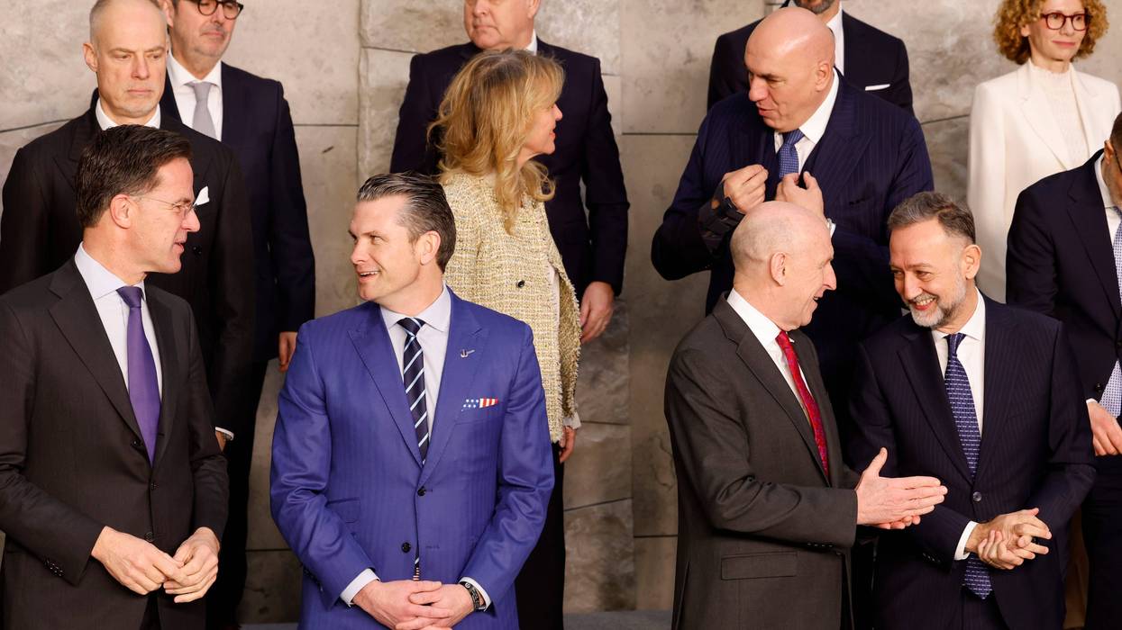 United States Secretary of Defense Pete Hegseth, front second left, speaks with NATO Secretary General Mark Rutte as they pose with other ministers during a group photo of NATO defense ministers at NATO headquarters in Brussels.