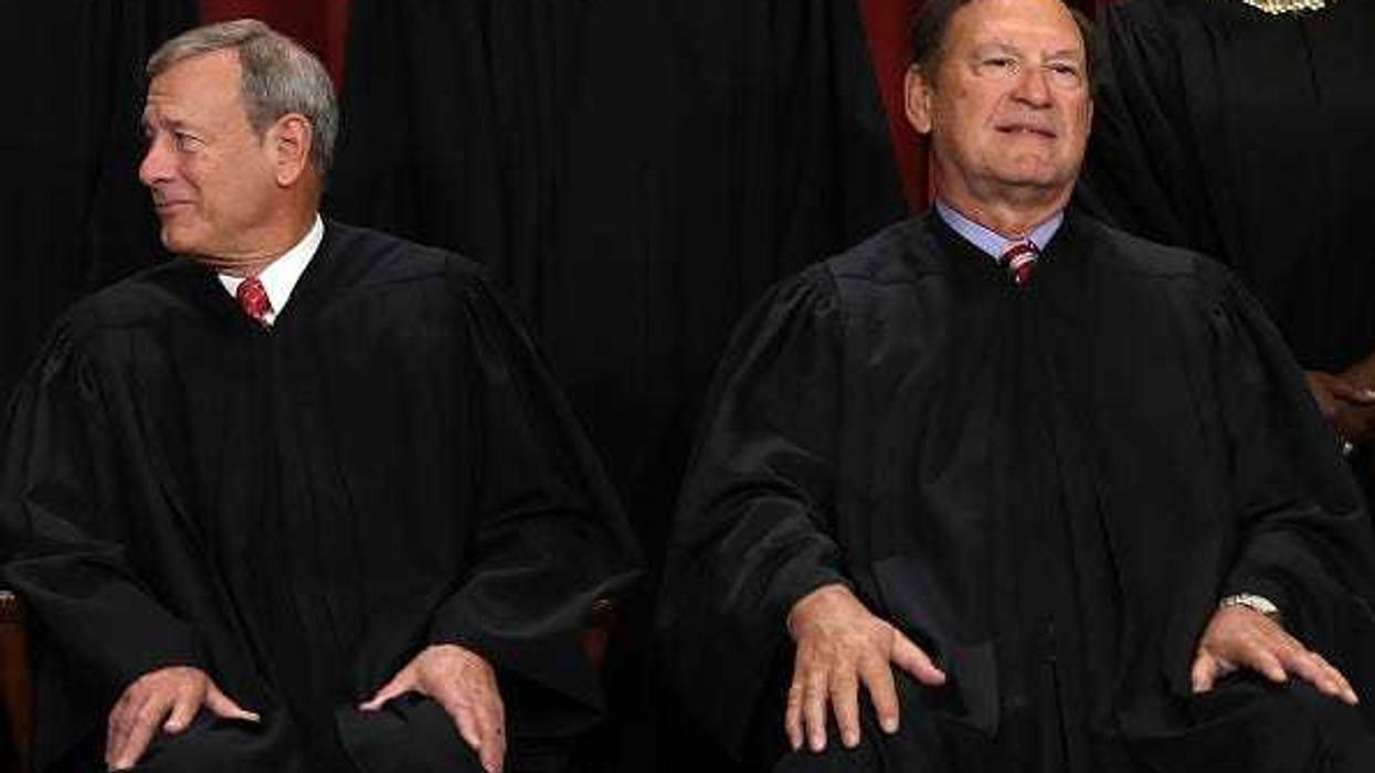 United States Supreme Court Chief Justice John Roberts (L) and Associate Justice Samuel Alito (R) pose for an official portrait at the East Conference Room of the Supreme Court building on October 7, 2022 in Washington, DC.