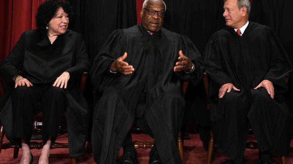 United States Supreme Court (L-R) Associate Justice Sonia Sotomayor, Associate Justice Clarence Thomas, and Chief Justice of the United States John Roberts pose for their official portrait at the East Conference Room of the Supreme Court building on October 7, 2022 in Washington, DC. The Supreme Court has begun a new term after Associate Justice Ketanji Brown Jackson was officially added to the bench in September.