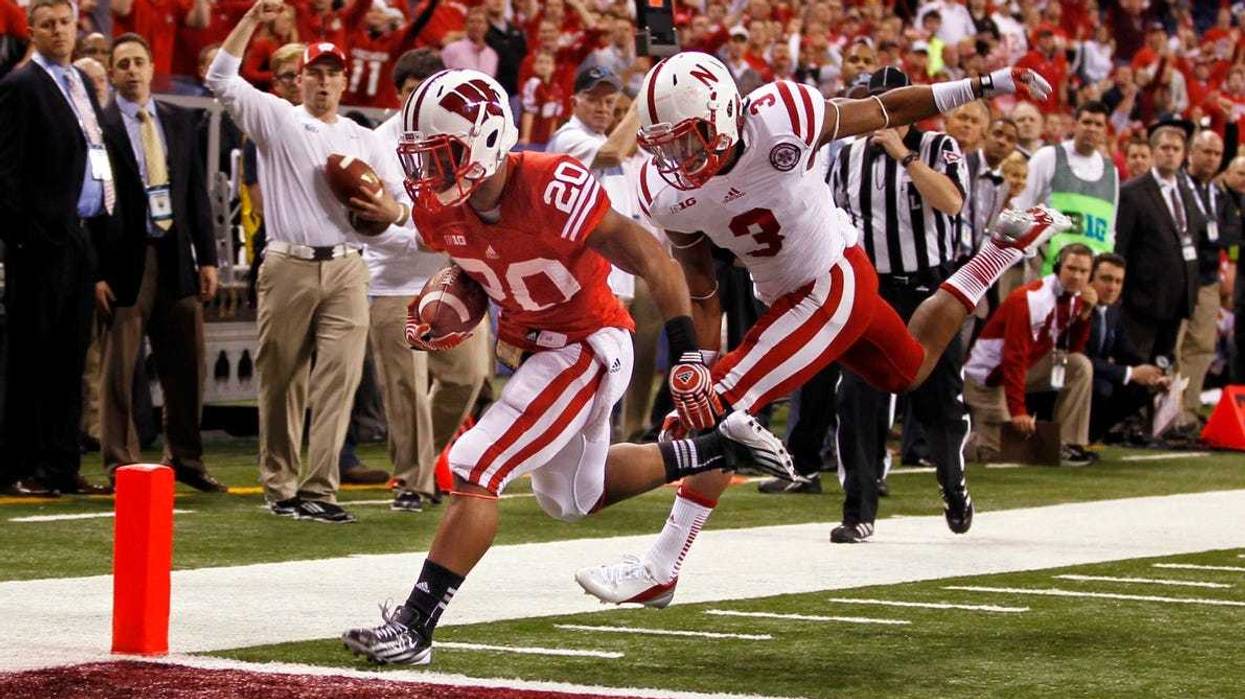 University of Wisconsin James White (20) ) scores a touchdown while being pursued by Nebraska QB Taylor Martinez in the first quarter during the 2012 Big Ten Championship football game at Lucas Oil Stadium in Indianapolis, Indiana on December 1, 2012.
