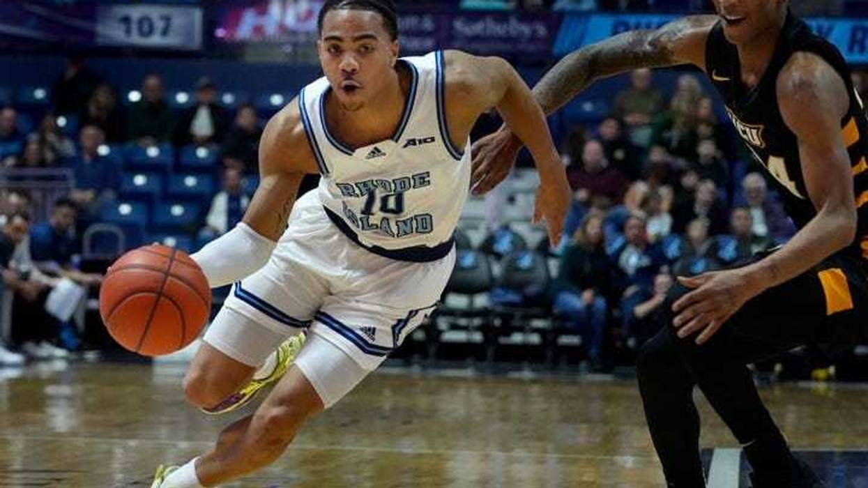 URI guard Ishmael Leggett slips past Nick Kern Jr. of VCU during first half action