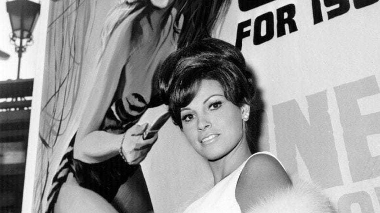 US actress Raquel Welch in London, in front of a poster promoting her latest film 'One Million Years BC'.