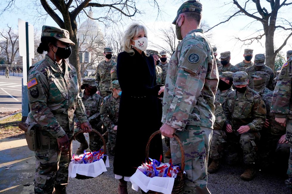 US First Lady Jill Biden surprises National Guard members outside the Capitol with chocolate chip cookies on January 22, 2021, in Washington, DC.