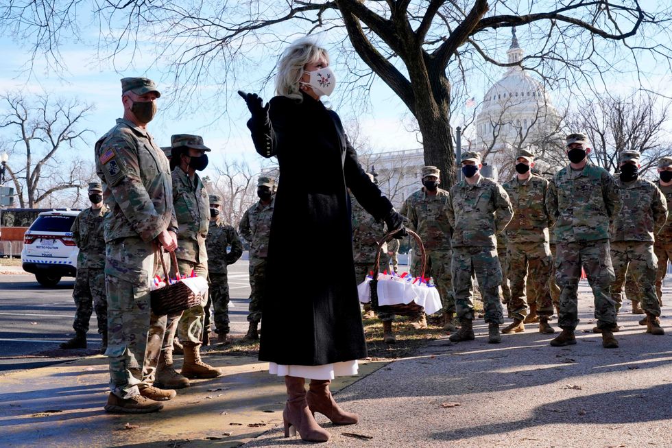 US First Lady Jill Biden surprises National Guard members outside the Capitol with chocolate chip cookies on January 22, 2021, in Washington, DC.