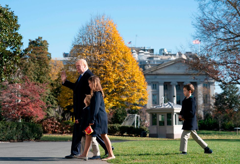 US President Donald Trump, followed by his grandchildren Arabella, Theodore, and Joseph, arrives at the White House on November 29, 2020 in Washington, DC. - President Trump spent the Thanksgiving weekend at Camp David and his Trump National Golf Course in Virginia.