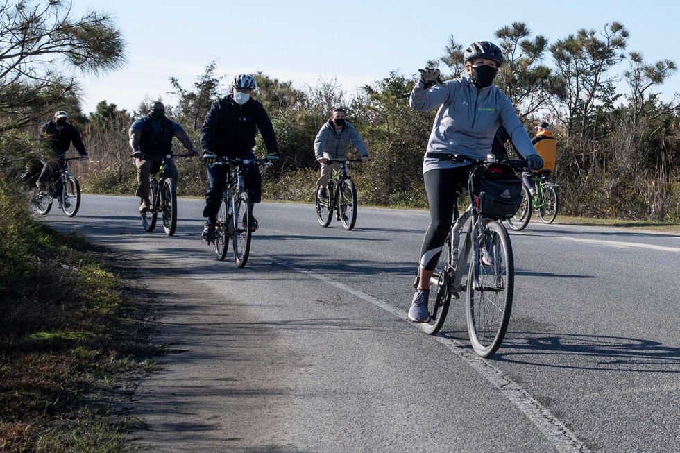 US President-elect Joe Biden (3rd L) and his wife Jill Biden (front) ride their bikes at Cape Henlopen State Park near Rehoboth Beach, Delaware, on November 14, 2020.