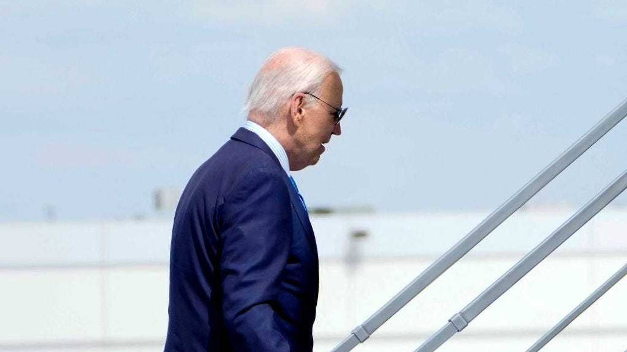 US President Joe Biden boards Air Force One as he departs Harry Reid International Airport in Las Vegas, Nevada, on July 17, 2024, en route to Delaware after testing positive for COVID-19.