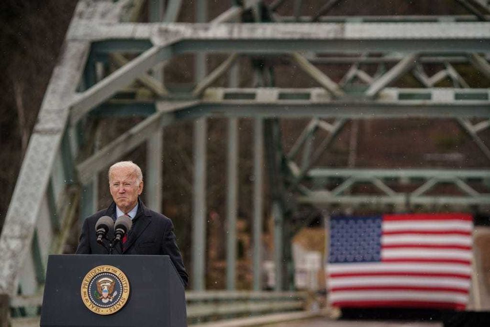 US President Joe Biden delivers a speech on infrastructure while visiting the NH 175 bridge spanning the Pemigewasset River on November 16, 2021 in Woodstock, New Hampshire. The visit to the bridge, listed in poor condition since 2013, follows the signing of the $1.2 trillion infrastructure bill on Monday. (Photo by John Tully/Getty Images)