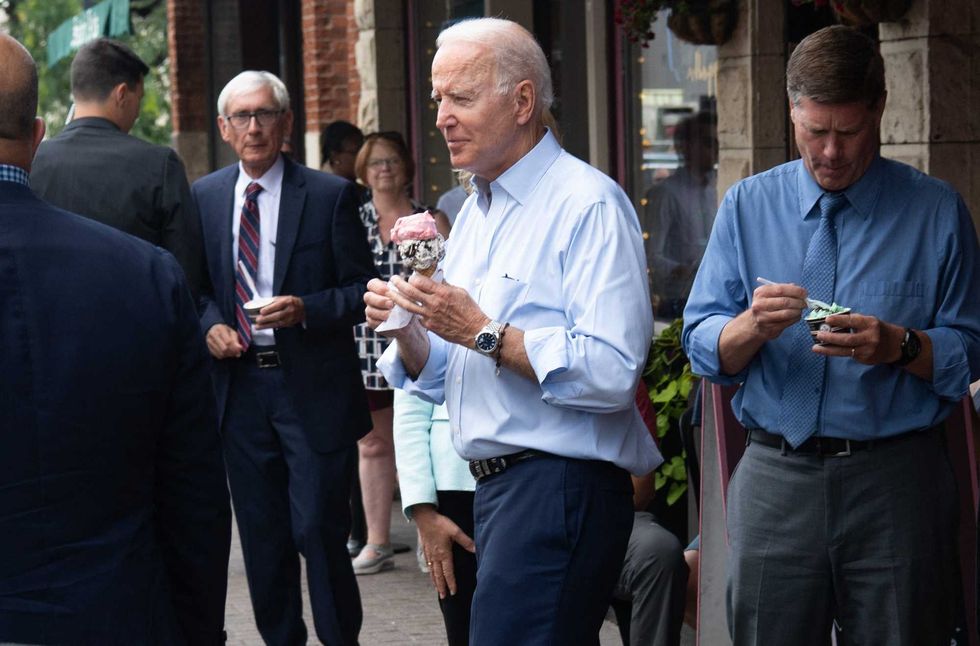 US President Joe Biden eats an ice cream cone while visiting the The Pearl Ice Cream Parlor & Confectionery in La Crosse, Wisconsin, June 29, 2021.