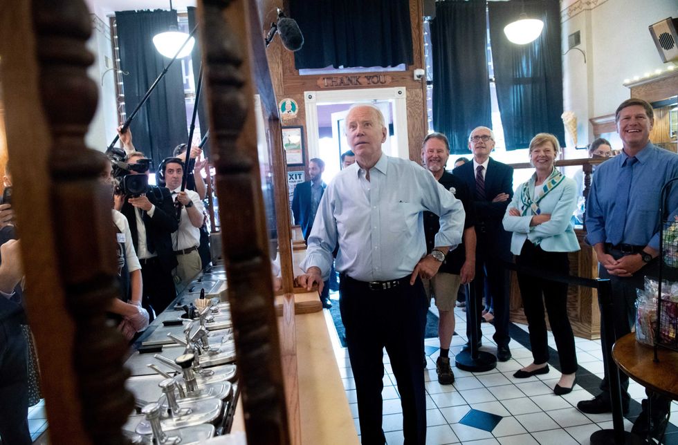 US President Joe Biden orders an ice cream cone while visiting the The Pearl Ice Cream Parlor & Confectionery in La Crosse, Wisconsin, June 29, 2021. - US President Joe Biden stood in an oily, machinery filled warehouse in Wisconsin to tout his multi-trillion dollar infrastructure plans Tuesday, arguing that America needs everything from better bridges to broadband to remain competitive.