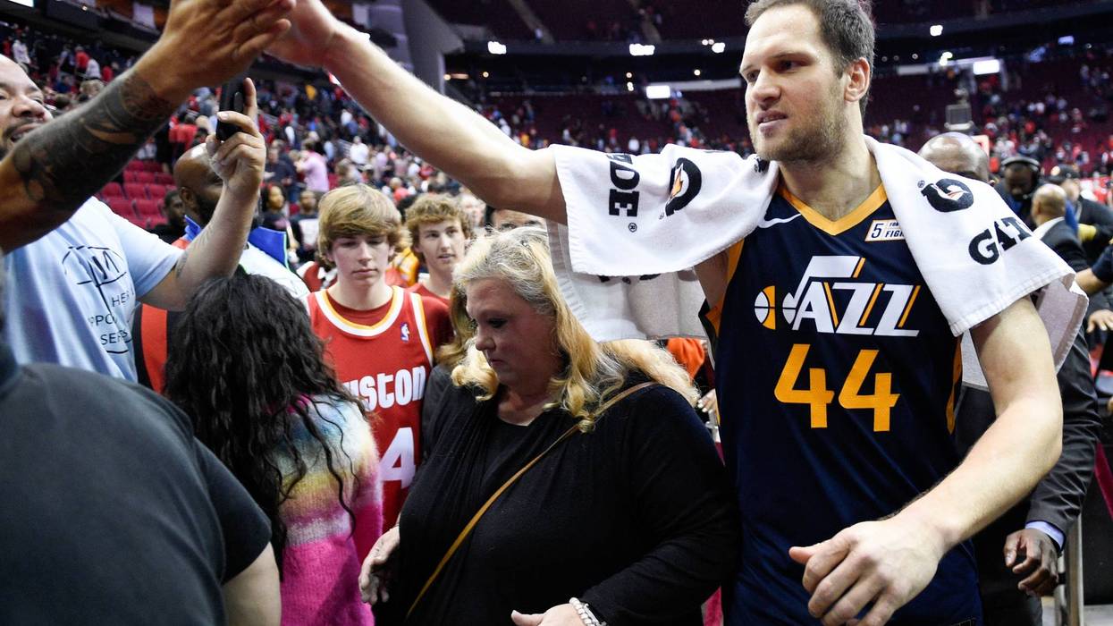 Utah Jazz forward Bojan Bogdanovic (44) high-fives a fan after shooting the game-winning three point basket during the second half of an NBA basketball game against the Houston Rockets, Sunday, Feb. 9, 2020, in Houston.