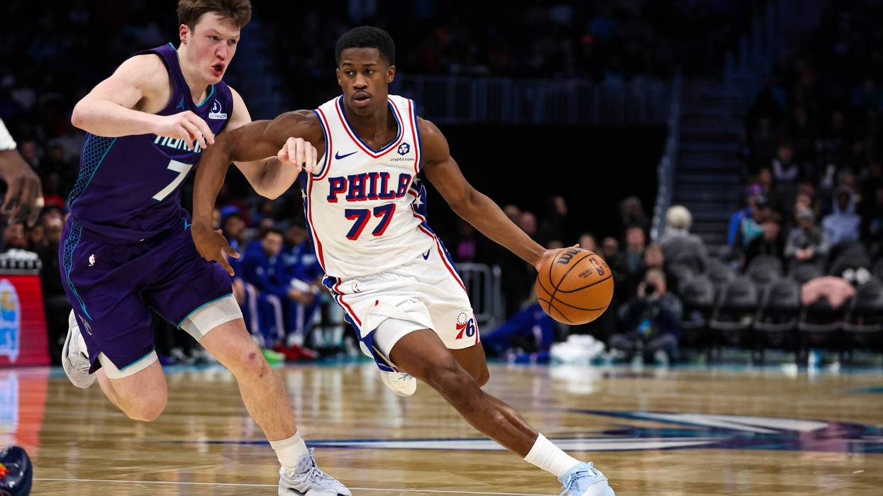 V.J. Edgecombe #77 of the Philadelphia 76ers drives by Kon Knueppel #7 of the Charlotte Hornets during the second half at Spectrum Center on January 26, 2026 in Charlotte, North Carolina.