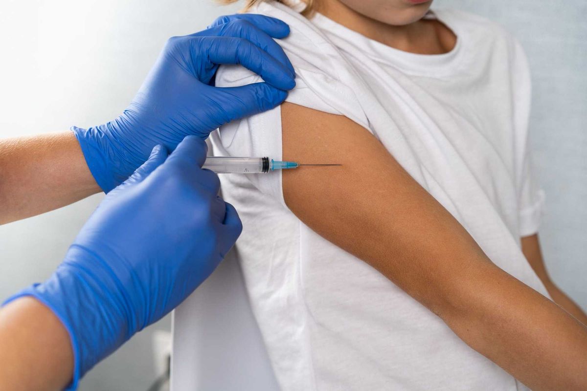 vaccination of children, a little boy at a doctor's appointment, an injection in the arm, children's medicine, an injection in the arm.